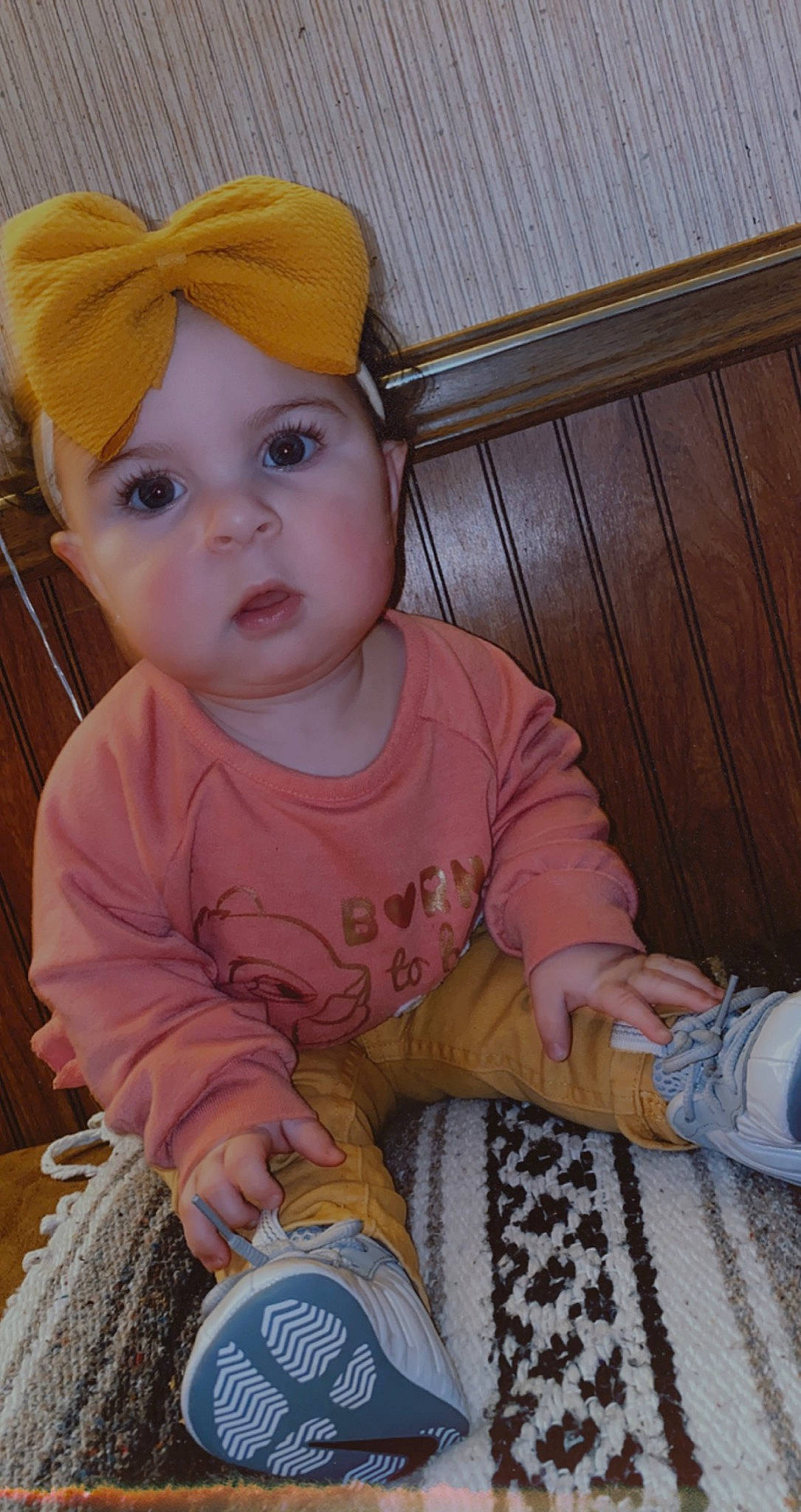 Grayson is registered to the contest to win money with this photo: baby, baby_products, baby_toddler_clothing, blue, cap, cheek, child, eye, fashion_accessory, flooring, fun, head, iris, pattern, person, sitting, skin, sleeve, t_shirt, toddler