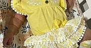 Jacie is registered to the contest to win money with this photo: adorable, baby, baby_clothes, bed, child, comfort, crib, cute, floral_sheet, indoor, infant, peaceful, person, portrait, resting, sleeping, smiling, sock, yellow_dress, young_child