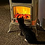 cat, tabby_cat, electric_fireplace, fire, carpet, indoor, warmth, cozy, curious, pets, home_interior, furniture, glowing, logs, heat, relaxation, animal, mammal, domestic_cat, sitting