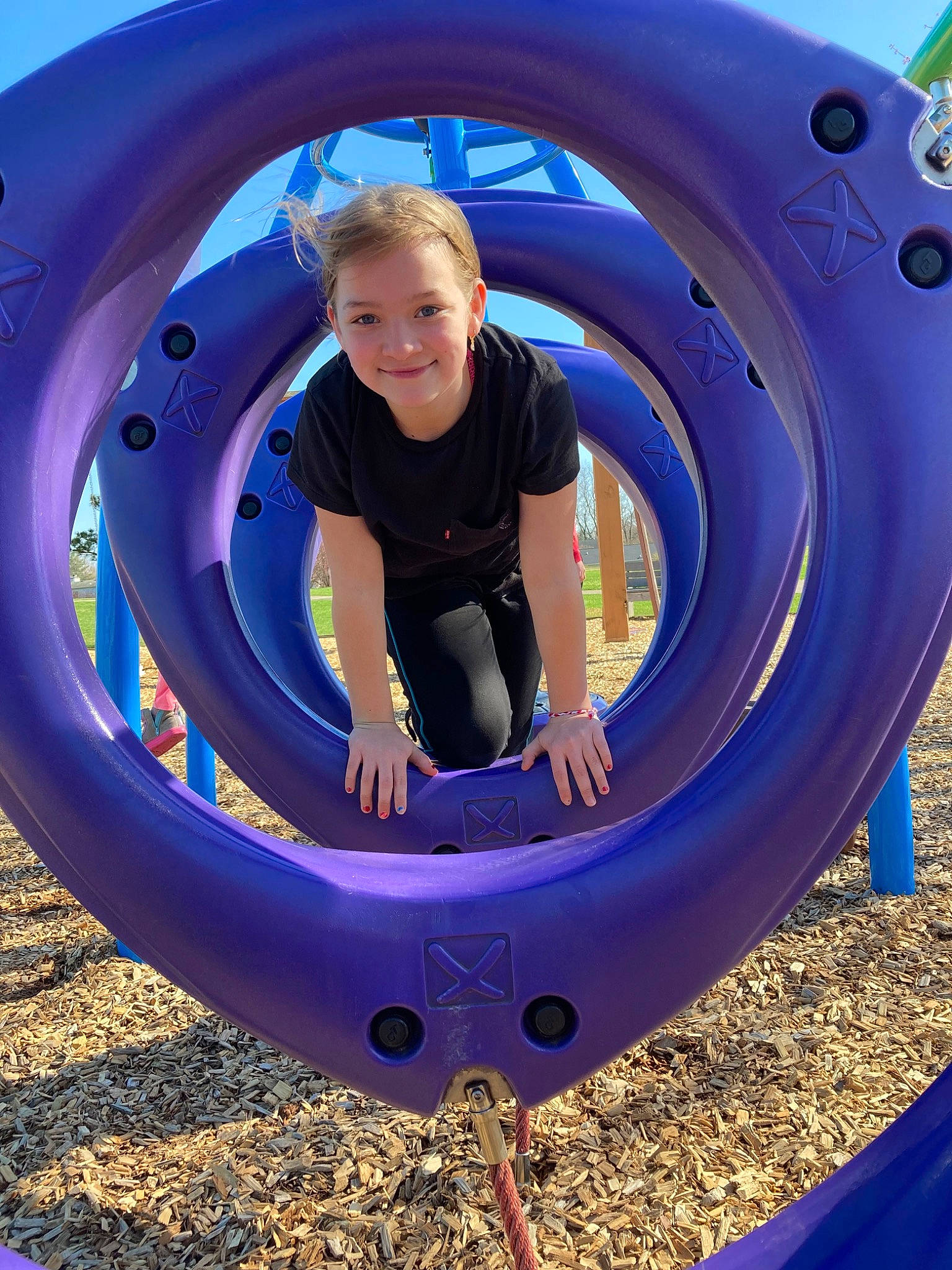 Delila is registered to the contest to win money with this photo: automotive_tire, blue, circle, comfort, electric_blue, fun, grass, happy, joy, leisure, nature, organ, person, play, playground, recreation, rim, smile, symmetry, synthetic_rubber