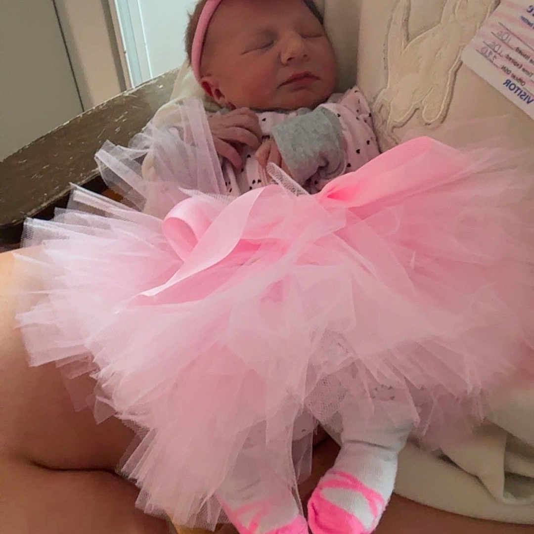 Azriella joined the competition — help win amazing prizes! baby, closeup, clothing, cozy, cute, fabric, hands, headband, holding, indoor, infant, legs, newborn, person, pink_tutu, resting, sleeping, socks, soft_lighting, tulle