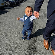 Lucas joined the competition — help win amazing prizes! child, toddler, boy, suit, bow_tie, walking, hand_holding, adult, parking_lot, cars, outdoor, pavement, sunlight, shadow, formal_clothing, smile, person, footwear, nature, greenery