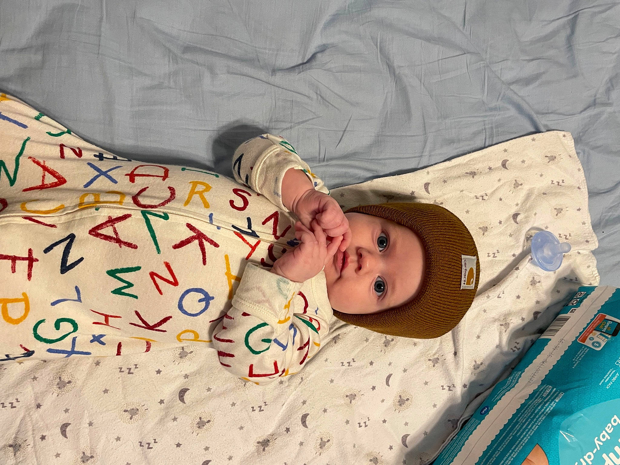 Laine is registered to the contest to win money with this photo: baby, baby_products, baby_safety, baby_sleeping, baby_toddler_clothing, bed_sheet, bedding, bedtime, child, comfort, hat, head, headwear, linens, mammal, nap, pattern, person, room, sleeve