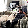 Frazier is registered to the contest to win money with this photo: blanket, butterfly, casual, computer, couch, cozy, decorations, dog, fluffy_dog, hand_gesture, indoor, laptop, living_room, monitor, peace_sign, person, pillow, remote_control, smiling, sticky_notes