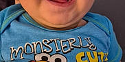 Alister is registered to the contest to win money with this photo: baby, infant, smiling, blue_onesie, sesame_street, elmo, big_bird, cookie_monster, oscar_the_grouch, clothing, cute, face, happy, child, portrait, indoor, closeup, person, expression, gloves