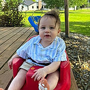 Cito joined the competition — help win amazing prizes! baby, child, outdoor, red_baby_seat, wooden_deck, grass, trees, blue_swing, striped_shirt, socks, face, person, cute, sunny, daylight, greenery, smile, happy, casual_clothing, nature