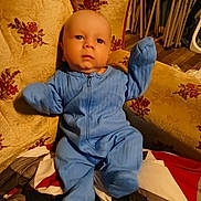 Kingsley joined the competition — help win amazing prizes! baby, blue_onesie, armchair, floral_pattern, blanket, indoor, child, person, infant, furniture, face, cute, seated, expression, soft_lighting, wood_floor, home, cozy, raised_arms, portrait