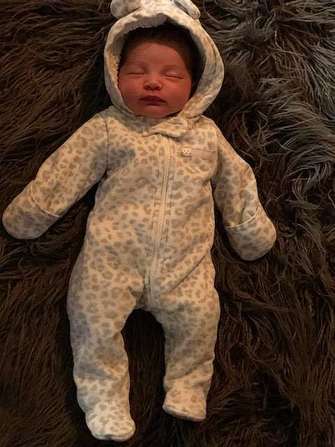 Odessa is registered to the contest to win money with this photo: baby, brown, child, fur, outerwear, person, smile, toddler, wool