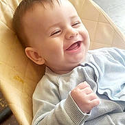 Caolán joined the competition — help win amazing prizes! baby, smile, happy, infant, child, face, clothing, sweater, hand, fist, seat, cushion, indoor, cute, joy, young, person, portrait, skin, head