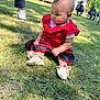 Normani is registered to the contest to win money with this photo: baby, child, grass, outdoor, red_clothing, black_clothing, shoes, person, tent, house, sunny, daylight, curly_hair, earrings, sitting, greenery, people, casual, footwear, nature