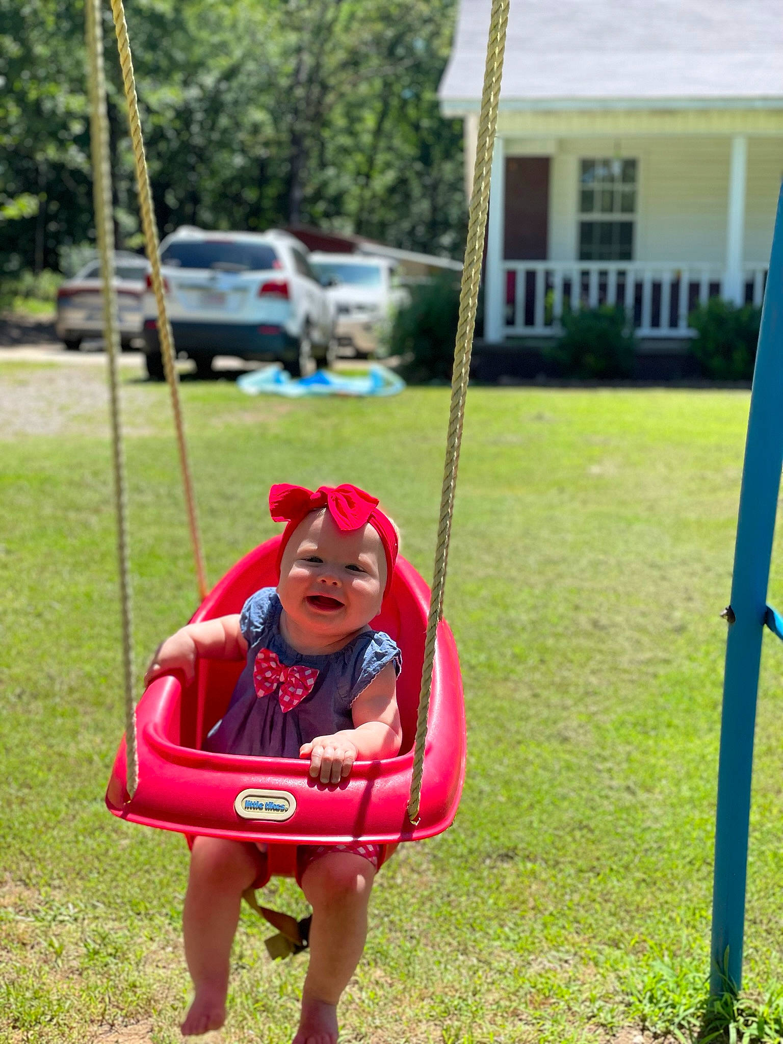 Braylee joined the competition — help win amazing prizes! car, city, fun, grass, headwear, lawn, leisure, outdoor_play_equipment, person, plant, playground, recreation, shorts, summer, sunglasses, swing, tire, toddler, tree, vehicle