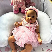 Stevie joined the competition — help win amazing prizes! baby, infant, pink_dress, headband, plush_toy, stuffed_giraffe, cushion, nursery, patterned_bedding, rainbow, stars, soft_toys, child, indoors, portrait, cute, toddler, clothing, relaxing, smiling