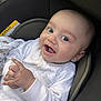 Mikaeel is registered to the contest to win money with this photo: baby, infant, car_seat, smiling, white_clothing, onesie, hands, face, happy, cute, child, young, seat, safety, indoor, portrait, expression, skin, person, newborn