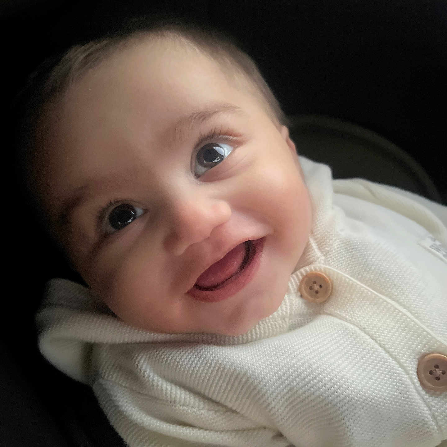 Mikaeel joined the competition — help win amazing prizes! apparel, baby, button, car_seat, child, close_up, cozy, cute, expression, eyes, face, happy, indoors, infant, knitted, portrait, seat, smiling, warm_clothing, white_sweater