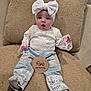 Jayde is registered to the contest to win money with this photo: baby, infant, child, five_months, headband, bow, white_clothing, lace, denim_pants, sitting, cushion, beige, plaque, age_marker, cute, expression, indoors, portrait, soft_texture, face