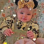 baby, infant, headband, sparkles, heart_lights, blanket, mickey_mouse, cute, smiling, child, seated, soft_toys, patterned_fabric, indoor, comfort, clothing, face, hands, adorable, portrait