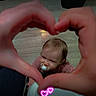 toddler, child, pacifier, hands, heart_shape, high_chair, floor, kitchen, smile, baby, infant, neon_hearts, cute, indoors, looking_up, person, playful, seat, wood_floor, happy