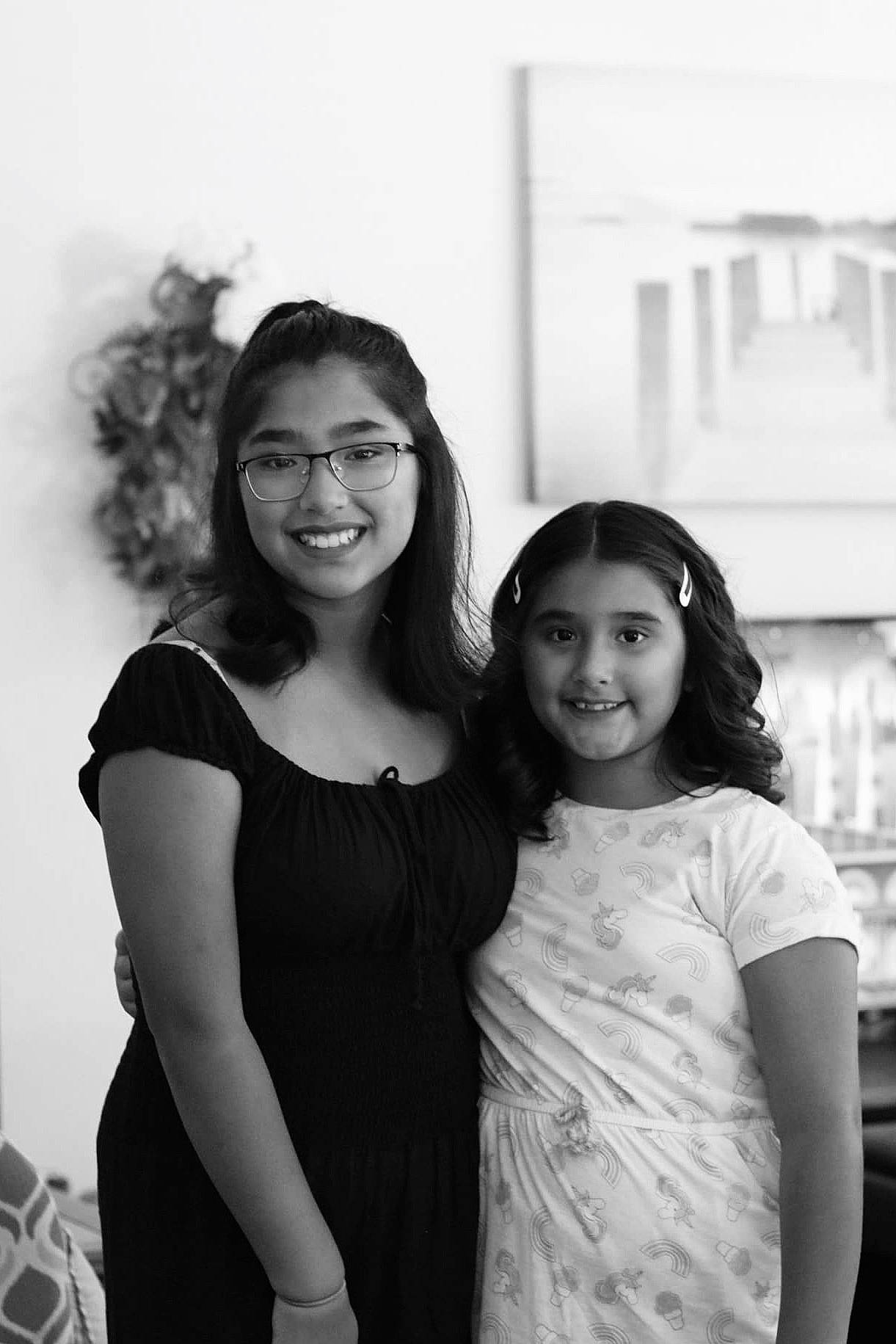 Janelle is registered to the contest to win money with this photo: black, black_and_white, dress, eyewear, facial_expression, fashion, flash_photography, gesture, glasses, hairstyle, happy, interaction, iris, joy, person, photograph, shoulder, smile, style, vision_care