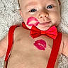 baby, infant, face, blue_eyes, red_bow_tie, red_suspender, lipstick_kiss, shirtless, denim_pants, soft_blanket, smile, cute, portrait, child, lying_down, skin, closeup, adorable, happy, baby_fashion