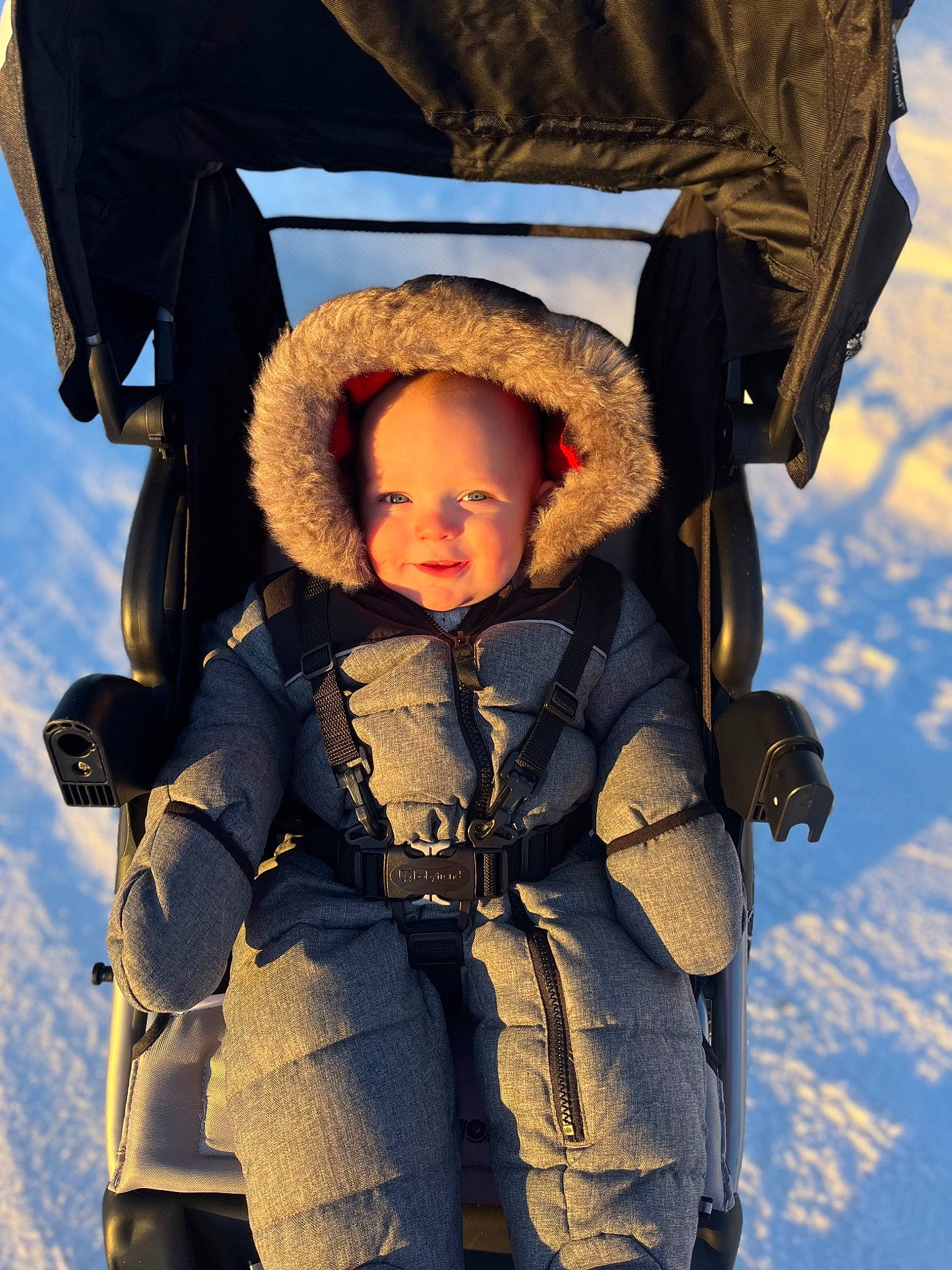 Chandler is registered to the contest to win money with this photo: baby, baby_carriage, baby_products, baby_toddler_clothing, child, electric_blue, eye, flash_photography, freezing, fun, glove, happy, jacket, people_in_nature, person, skin, smile, snow, toddler, travel