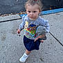 Elaina is registered to the contest to win money with this photo: toddler, child, sidewalk, doll, toy, sneaker, clothing, sweatshirt, skirt, hair_bow, pony_tail, urban, car, curb, concrete, determined, walking, outdoor, cute, person