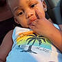 toddler, child, face, hand, fingers, tank_top, sunlight, car_interior, earring, person, portrait, holding, container, skin, young_child, casual_clothing, window, closeup, expression, seated