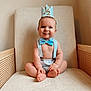 Landon is registered to the contest to win money with this photo: accessories, baby, chair, clothing, couch, crown, face, formalwear, furniture, happy, hat, head, jewelry, pants, person, photography, portrait, sitting, smile, tie