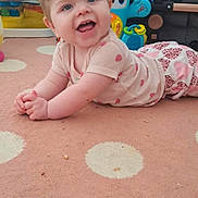 Sienna is registered to the contest to win money with this photo: baby, child, smile, happy, indoor, carpet, toy, colorful, face, crawling, clothing, pink, pattern, home, cute, infant, playful, room, person, portrait