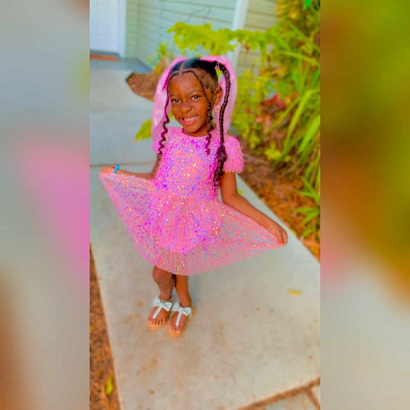 Ariel joined the competition — help win amazing prizes! child, clothing, dancing, dress, face, female, footwear, girl, hair, happy, hat, head, outdoors, person, photography, portrait, sandal, shoe, sitting, smile