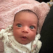 Saroya joined the competition — help win amazing prizes! baby, infant, face, eyes, expression, blanket, pink, clothing, onesie, cute, portrait, skin, head, newborn, lying_down, child, adorable, fluffy, soft, curious