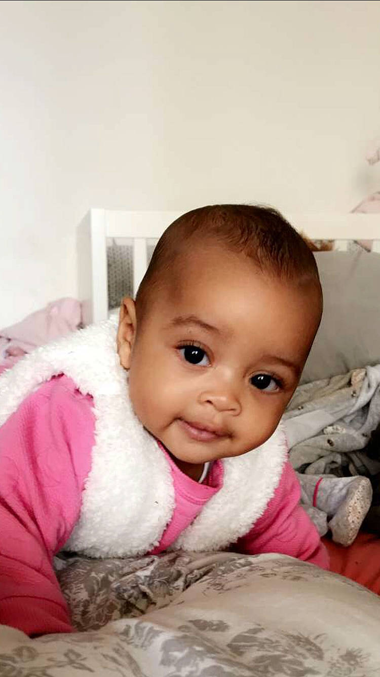 Phoebe participe au concours pour gagner de l'argent avec cette photo : baby, beauty, black_hair, cheek, child, ear, eye, eyebrow, face, happy, head, iris, lip, mouth, nose, person, pink, sitting, skin, smile