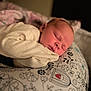 Willow is registered to the contest to win money with this photo: baby, sleeping, infant, cozy, blanket, patterned_cushion, floral, bird, soft_lighting, peaceful, cute, close_up, portrait, child, resting, warm, indoors, clothing, newborn, face