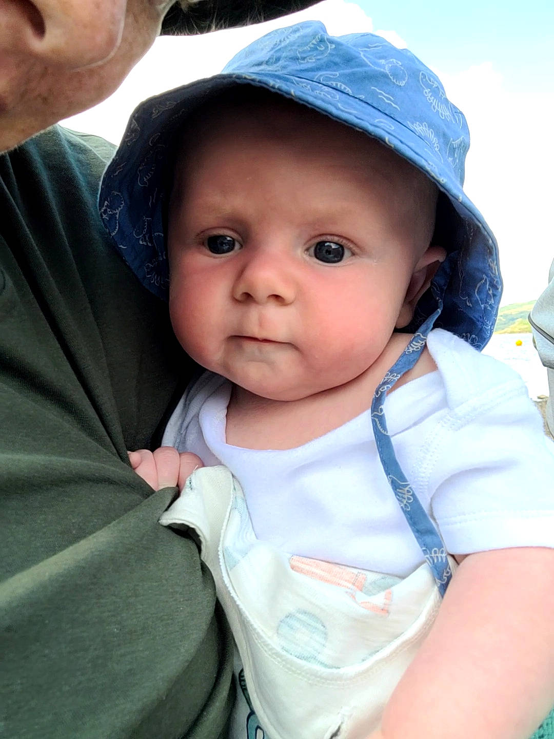 Finley is registered to the contest to win money with this photo: baby, baby_toddler_clothing, cap, cheek, child, face, facial_expression, fashion_accessory, fun, gesture, grass, happy, hat, headgear, headwear, lip, people, person, skin, sky
