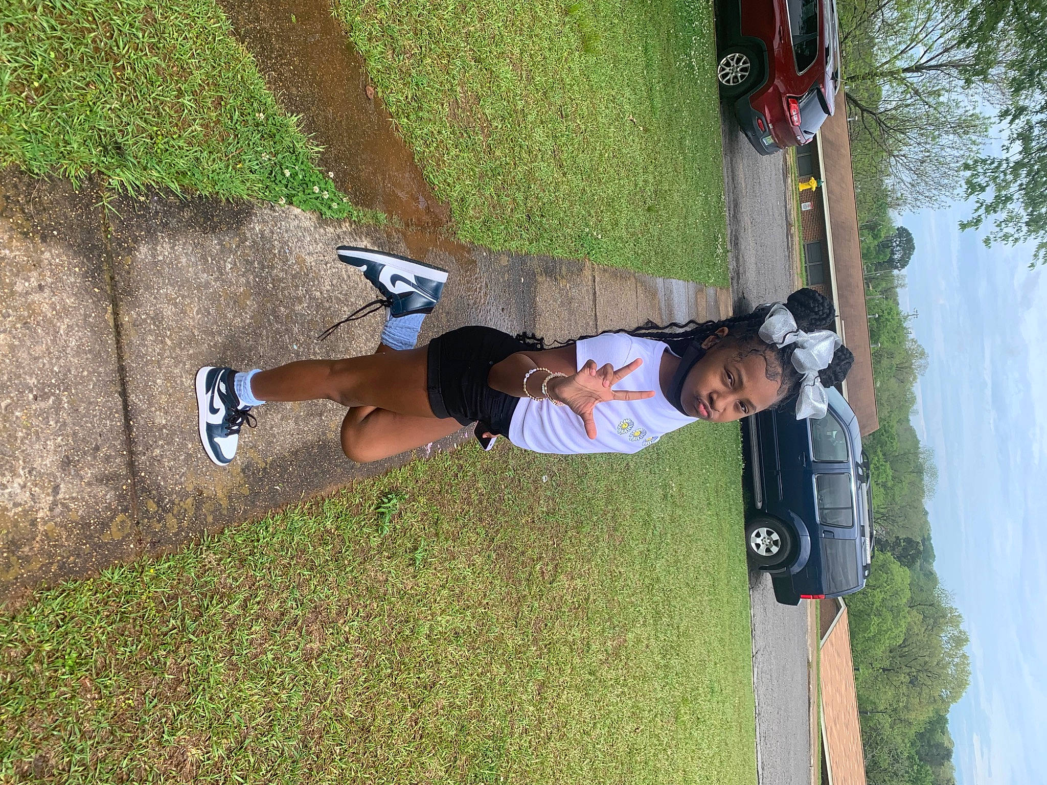 Janiyah joined the competition — help win amazing prizes! car, fun, grass, human_leg, knee, leisure, person, plant, recreation, shadow, sky, sports, sports_uniform, thigh, tree, vehicle_door, walking_shoe