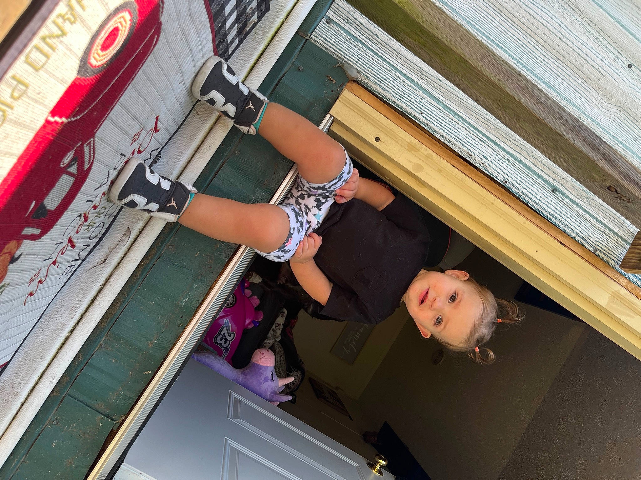 Ava is registered to the contest to win money with this photo: automotive_exterior, building, ceiling, elbow, facade, fun, human_body, human_leg, leisure, machine, magenta, person, recreation, room, sandal, shorts, thigh, waist, wheel, window