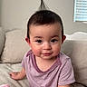 Alexus is registered to the contest to win money with this photo: baby, child, infant, cute, hair, tuft, striped_clothing, purple, onesie, couch, sofa, beige, indoor, portrait, sitting, curious, face, eyes, skin, person