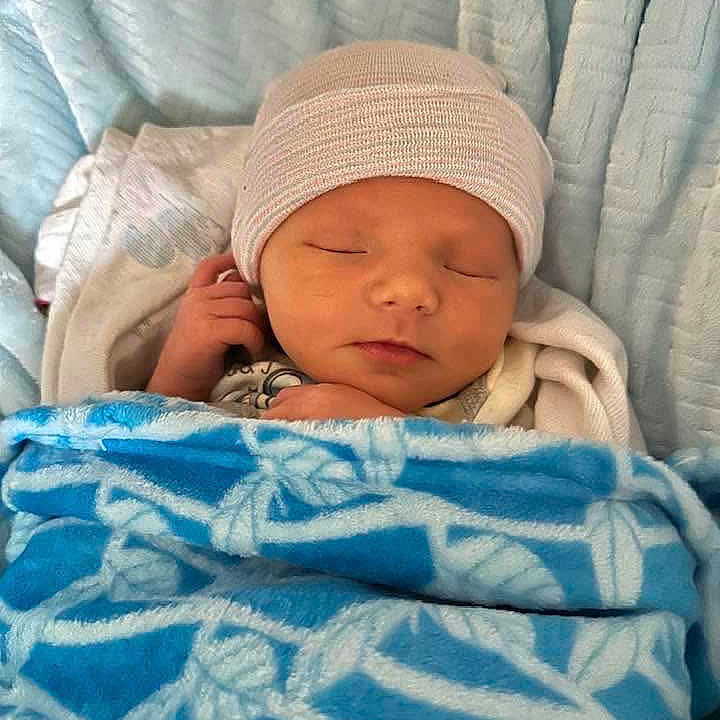 Hank joined the competition — help win amazing prizes! architecture, baby, bed, blanket, building, cap, clothing, face, furniture, glove, hat, head, hospital, newborn, person, photography, portrait, quilt, sleeping, towel