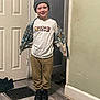 Liam is registered to the contest to win money with this photo: child, boy, smiling, indoor, beanie, jacket, nike_tshirt, pants, black_shoes, wood_floor, door, vent, wall, standing, casual_clothing, happy, person, portrait, cozy, fashion