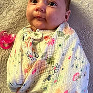 Elianna joined the competition — help win amazing prizes! baby, blanket, child, closeup, curious, cute, expression, face, floral_pattern, head, indoors, infant, looking, lying_down, newborn, pacifier, portrait, soft_texture, swaddle, wrapped