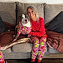 Olive Lucy joined the competition — help win amazing prizes! woman, dog, pajamas, grinch, couch, smile, indoor, pet, happy, holiday, matching_outfits, blanket, footwear, long_hair, wood_floor, casual, seated, home, cozy, friendship