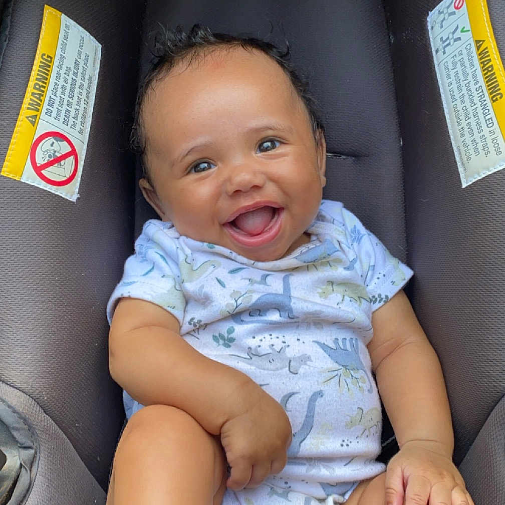 Kamari joined the competition — help win amazing prizes! baby, bodypart, car, clothing, cushion, face, finger, furniture, hand, happy, head, homedecor, laughing, person, photography, portrait, smile, t_shirt, transportation, vehicle