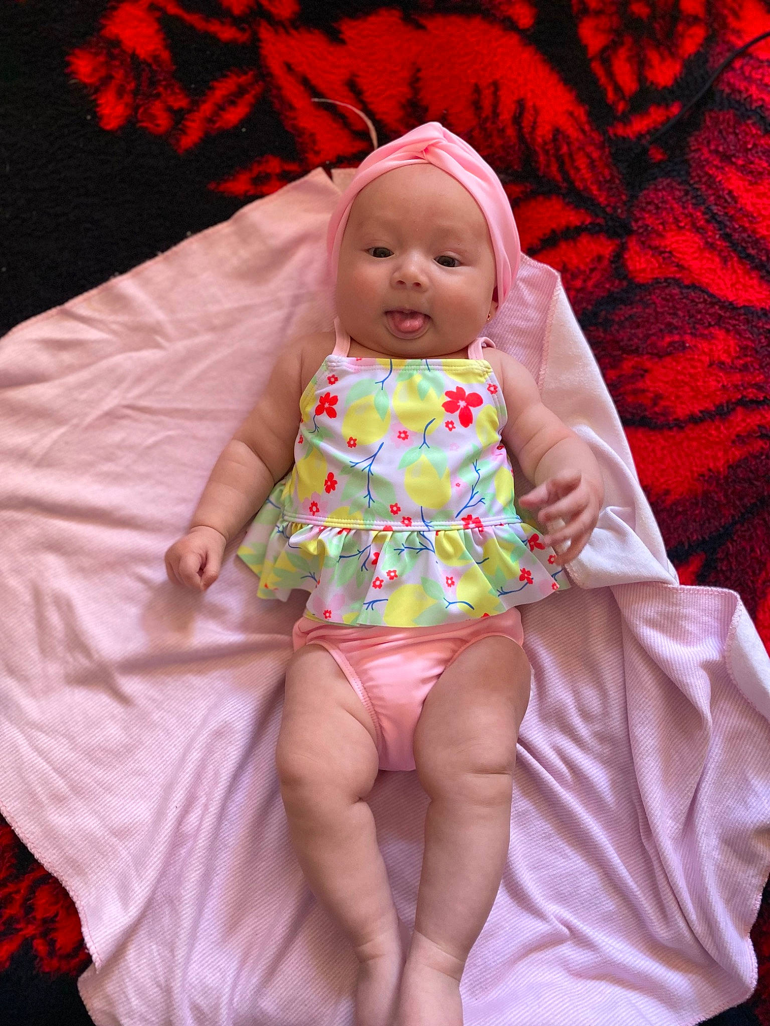 Kayleen is registered to the contest to win money with this photo: baby, baby_toddler_clothing, cheek, comfort, doll, dress, eye, head, headwear, human_body, human_leg, linens, magenta, pattern, person, pink, purple, sitting, skin, sleeve