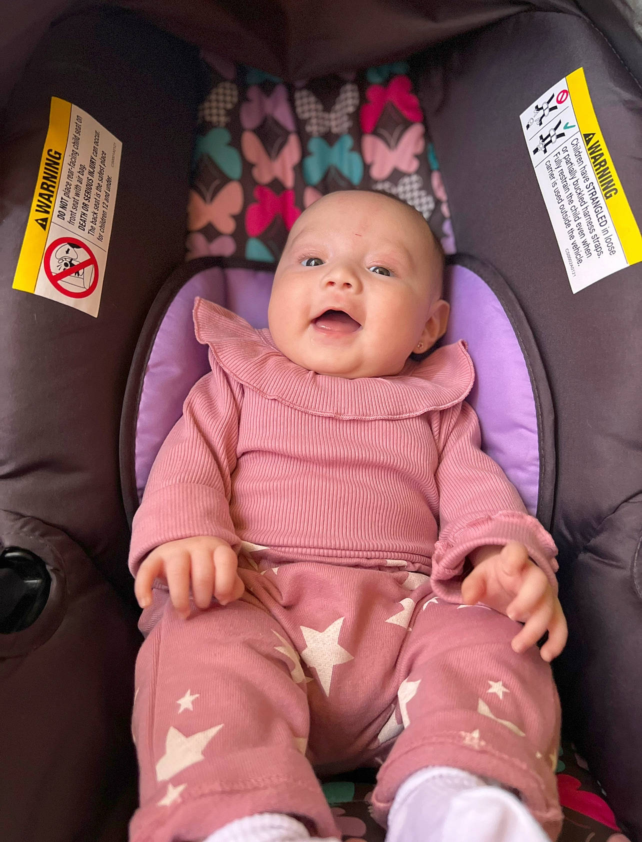 Kayleen is registered to the contest to win money with this photo: baby, baby_carriage, baby_toddler_clothing, car_seat, cheek, child, comfort, eye, head, lap, mouth, person, pink, product, purple, sitting, skin, sleeve, smile, textile