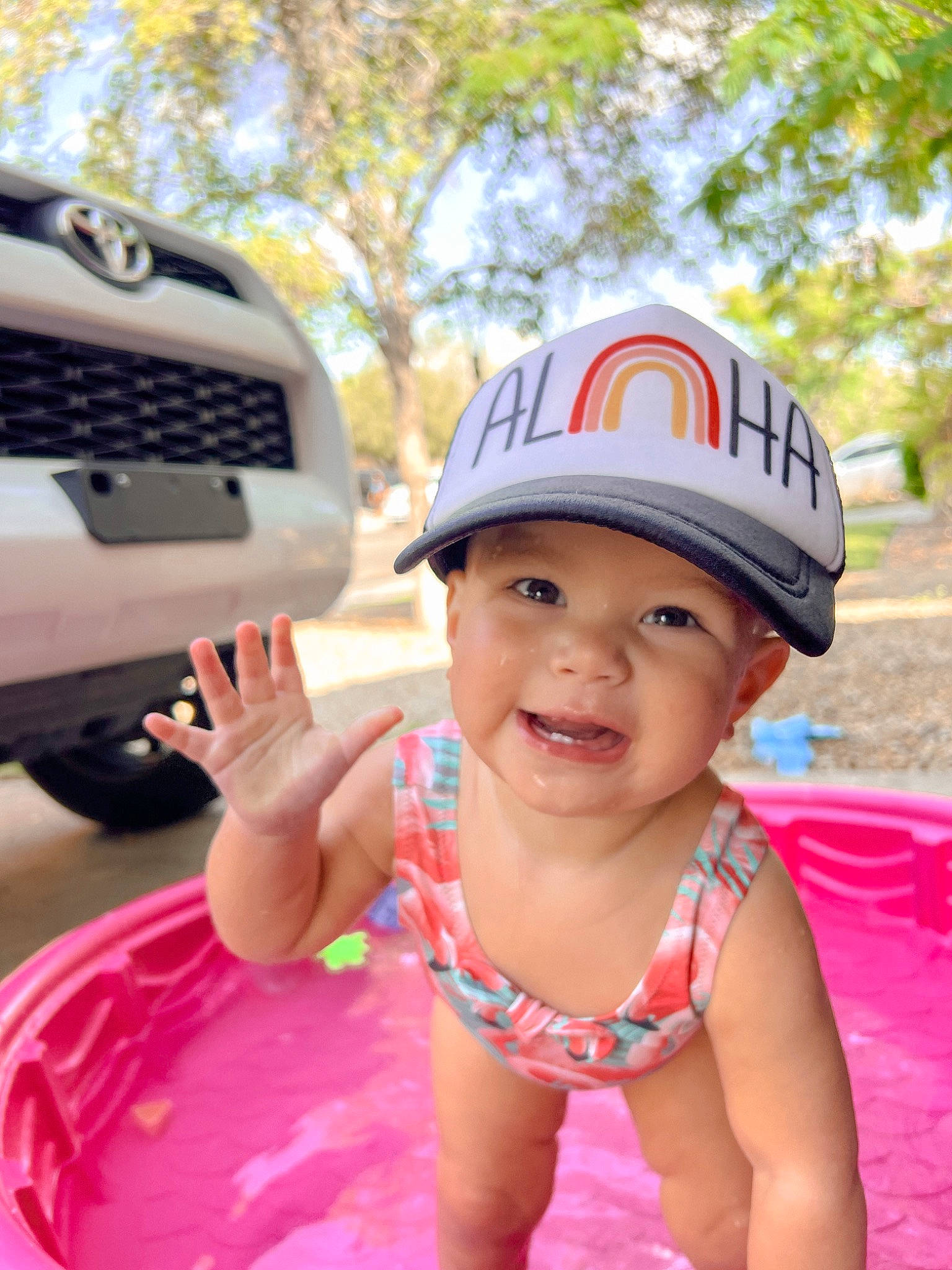 Ellie joined the competition — help win amazing prizes! automotive_exterior, automotive_lighting, automotive_tire, baby_toddler_clothing, bumper, cap, car, child, fun, grille, happy, headwear, hood, joy, leisure, magenta, motor_vehicle, person, personal_protective_equipment, pink