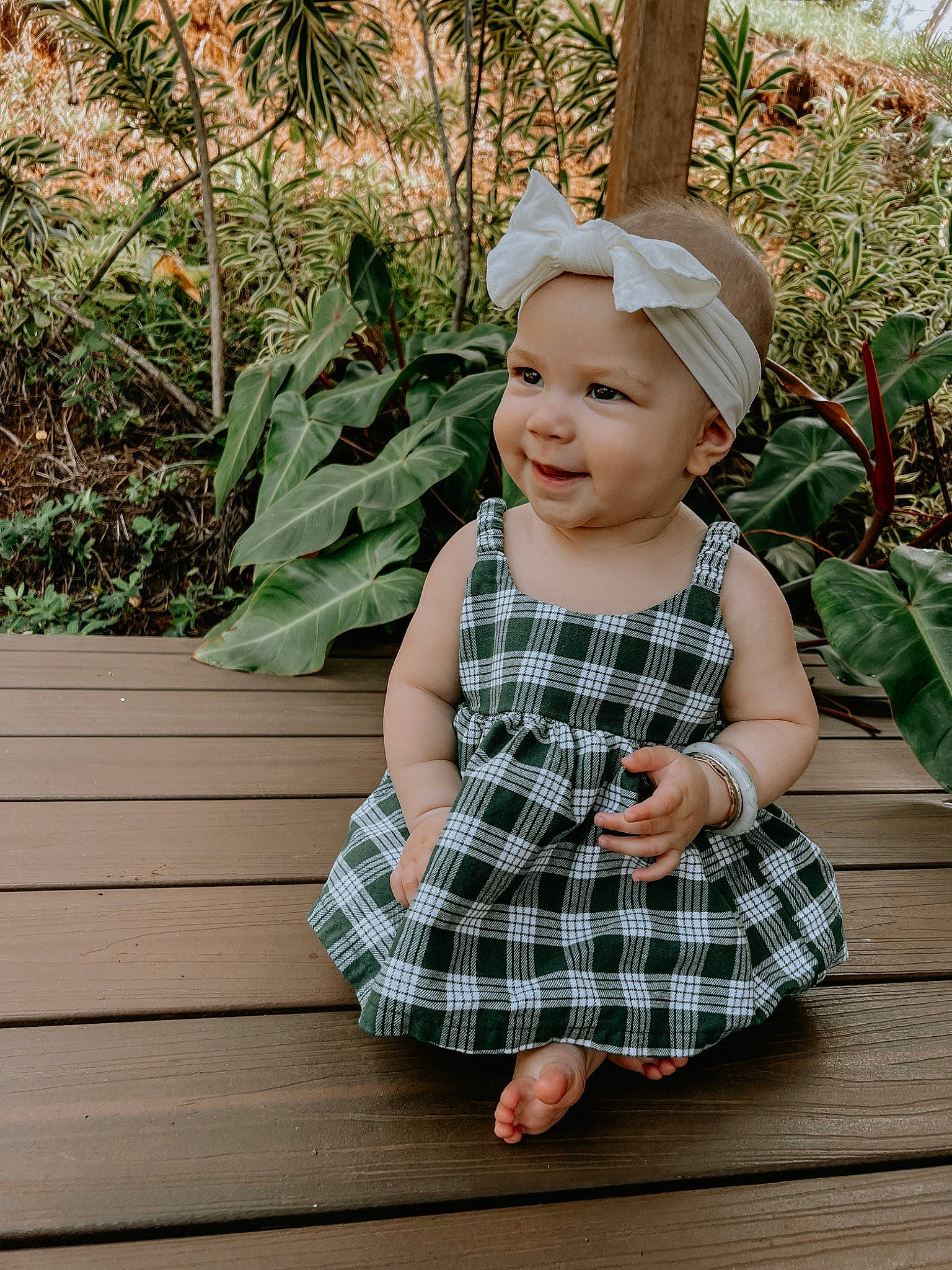 Ellie is registered to the contest to win money with this photo: baby, baby_toddler_clothing, child, clothing, fun, grass, happy, hat, headwear, joy, pattern, people_in_nature, person, plaid, plant, portrait_photography, sitting, skin, sleeve, smile
