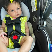Olivia Rose is registered to the contest to win money with this photo: baby, child, car_seat, safety_harness, yellow_bow, polka_dot_clothing, infant, seatbelt, cute, portrait, indoors, person, face, head, skin, feet, legs, hair, expression, car_interior