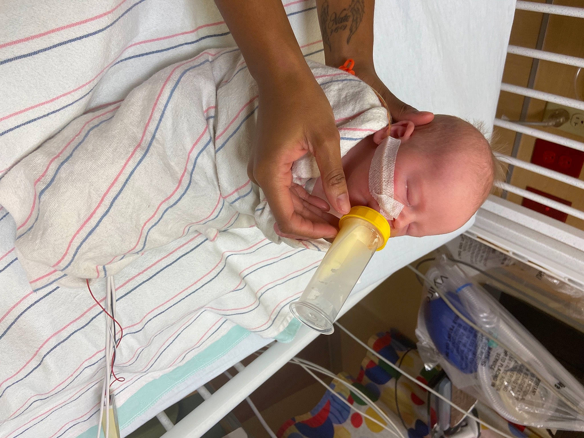 Dimitri is registered to the contest to win money with this photo: baby, baby_bottle, baby_products, baby_toddler_clothing, child, comfort, drinkware, flooring, foot, fun, glass, leisure, nail, person, plastic, plastic_bottle, play, room, thumb, toddler