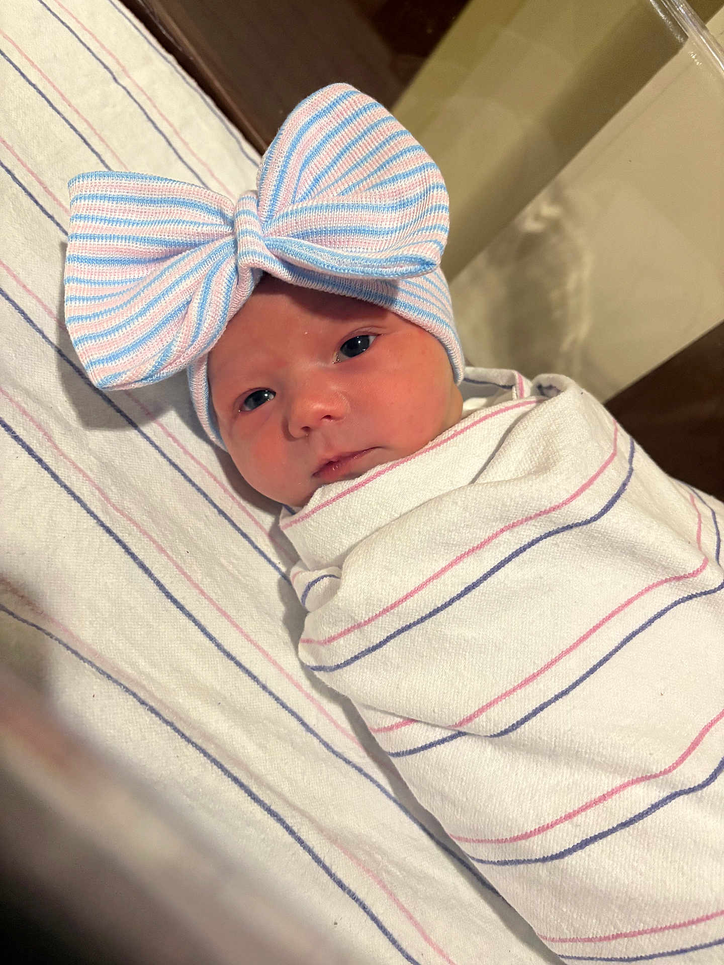 Emma is registered to the contest to win money with this photo: newborn, baby, wrapped, blanket, bow, hat, striped, face, infant, cute, sleepy, indoors, soft, headwear, portrait, child, person, resting, cozy, pink