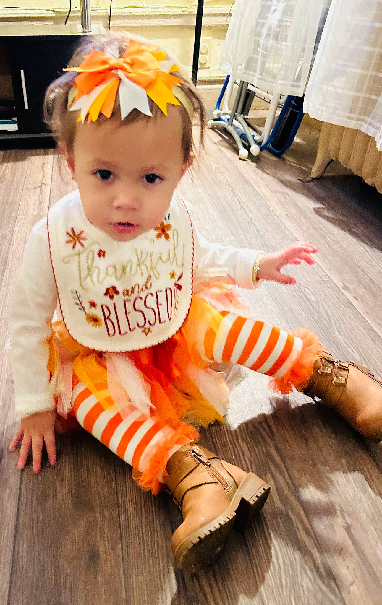 Jayliah joined the competition — help win amazing prizes! baby, baby_toddler_clothing, child, face, fashion_accessory, floor, flooring, fun, happy, hardwood, home_appliance, human_leg, orange, peach, person, sitting, sleeve, sock, toddler, wood