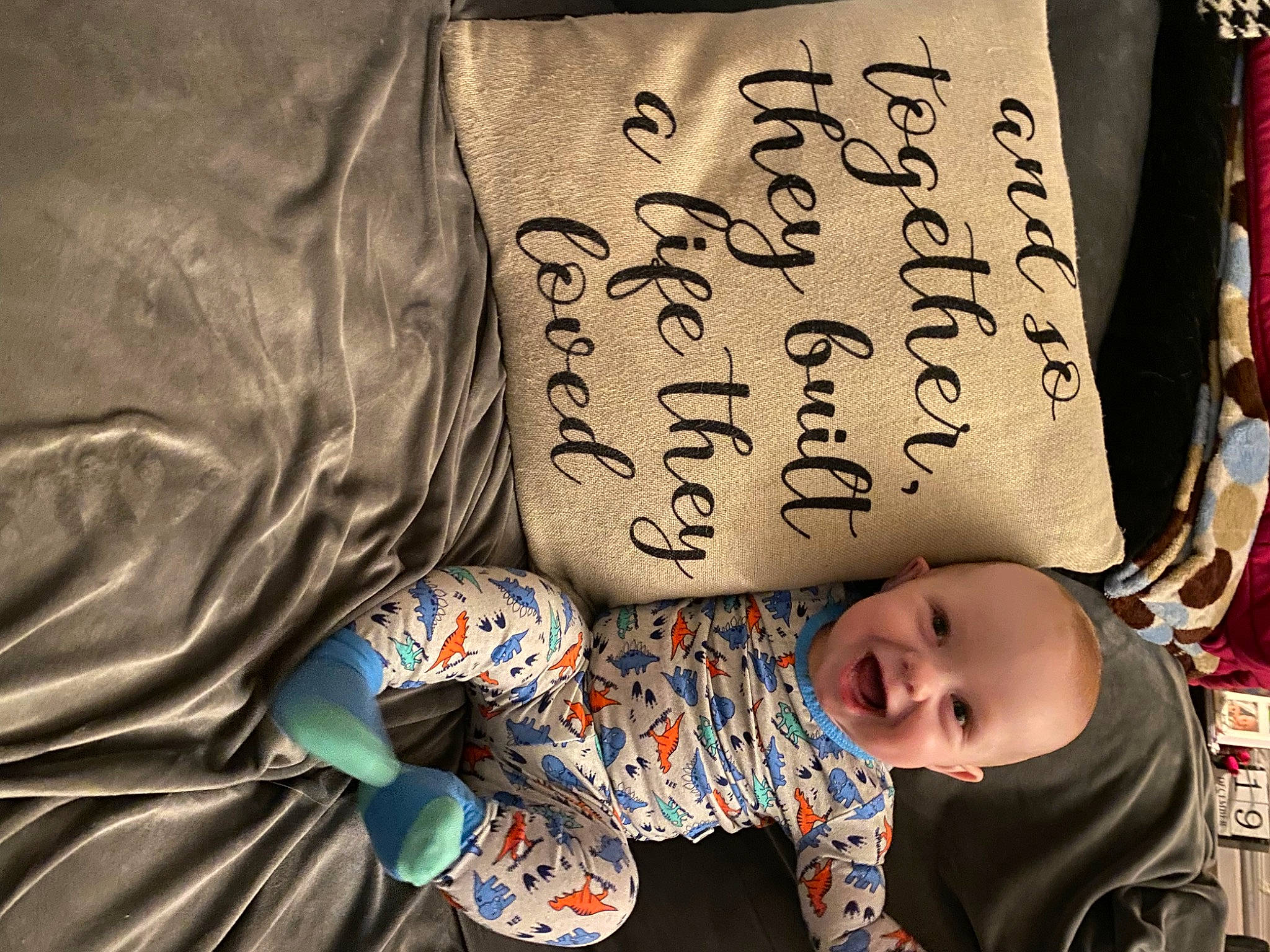 Orion is registered to the contest to win money with this photo: baby, baby_toddler_clothing, bedding, child, comfort, facial_expression, font, glasses, handwriting, happy, head, linens, person, pillow, room, sitting, sleeve, textile, toddler, tree